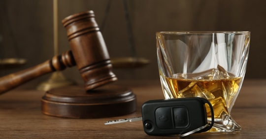 whiskey and keys next to gavel